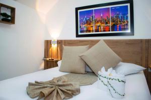 Un dormitorio con una cama con un cuadro en la pared. en Sixth House Suite, en Cali