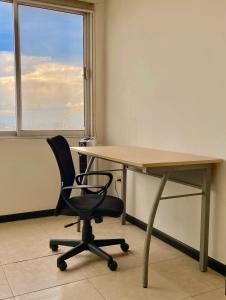 an office with a desk and a chair and a window at Ibis 8 in Monterrey