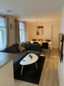 a living room with a blue couch and a table at 2 Bedroom Apartment Located Downtown Trondheim in Trondheim