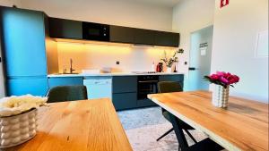 a kitchen with a wooden table and a wooden table sidx sidx sidx at Stara lipa Tašner kitchen & P & garage in Maribor