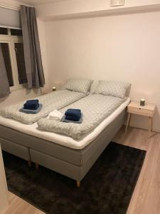 a bedroom with a bed with blue towels on it at 2 Bedroom Apartment Located Downtown Trondheim in Trondheim +11 photos