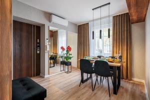 a dining room and living room with a table and chairs at Apartament Serbańska 1przez2 in Przemyśl