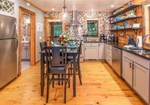 a kitchen with a table and chairs in it at Veteran Host Pets Allowed Sleeps 4 No Minimum Nights in Pigeon Forge