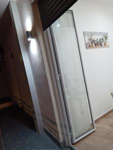 a glass door in a hallway with a picture on the wall at Vama House in Naples