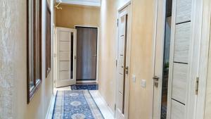 an empty hallway with a door and a rug at Home hearth - Домашний очаг in Dushanbe +17 photos