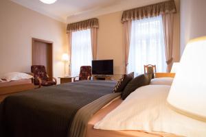a hotel room with a bed and a television at Hotel City Bell in Prague +37 photos