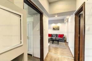 a corridor of a living room with a couch at Arcanum Apartman in Makó +20 photos