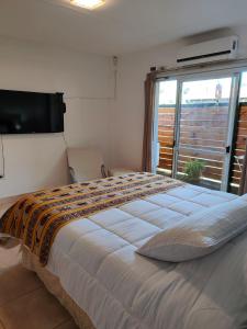 a bedroom with a large bed and a window at PATASTAY in San Salvador de Jujuy +28 photos