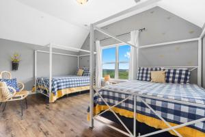 a bedroom with two beds and a window at Double-Sided Fireplace, Lake Views, Daily Tickets to Local Attractions, Air Hockey! in Branson +52 photos