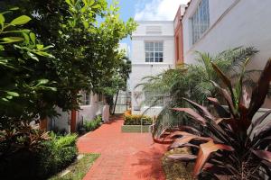 Una pasarela de ladrillos frente a una casa con plantas. en 2 Bedroom Apartment 3 Minute Walk to South Beach & Ocean Drive, en Miami Beach