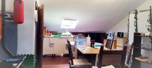 a kitchen with a table with chairs and a kitchen with at Castro-urdiales Apartamento 3 minutos de la playa in Castro-Urdiales +47 photos