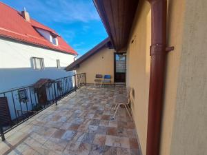 a balcony of a house with chairs on it at Casa Anna in Tîrnăveni