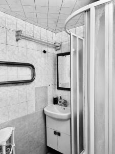 a bathroom with a sink and a mirror at Apartment near train station and close to city center in Kyiv +20 photos