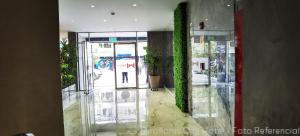 an entrance to a building with a green wall at MIRAFLORES CITY HOTEL in Lima