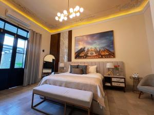 a bedroom with a large bed and a painting on the wall at GALA Hotel Boutique in Guadalajara +25 photos
