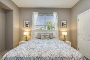a bedroom with a bed with two lamps and a window at 6 Mi to Coachella Festival Serene Studio in Indio