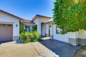 a house with a driveway and a garage at 6 Mi to Coachella Festival Serene Studio in Indio