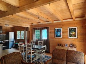 a kitchen and dining room with a table and chairs at Le chalet Péi Cosy & Nature proche de Périgueux in Marsaneix