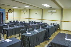 a room filled with tables and chairs with a clock at The Inn by Ilawu in Pietermaritzburg +145 photos
