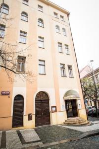 a large building with two doors on a street at Hotel City Bell in Prague