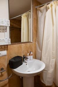 a bathroom with a sink and a mirror and a shower at Vera Playa apartment in Vera