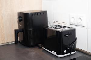 a black appliance sitting on a counter in a kitchen at GME Easy FlexHome Berlin Spandau in Berlin