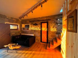 a living room with a couch and a brick wall at Villa Cserhegy Vendégház Tihany in Tihany +16 photos
