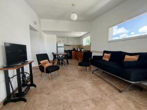 a living room with a couch and a tv at LA CASA Nostra in Valle Hermoso