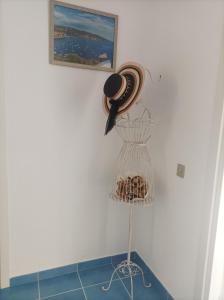 a hat on a wall next to a rack of shells at Villa Giardino degli oleandri Palinuro in Palinuro