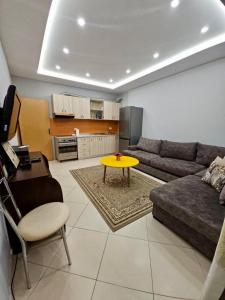 a living room with a couch and a table at Tirana Apartment in Kashari