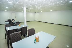 an empty room with tables and chairs in a building at Hotel Playa Divina in Coveñas