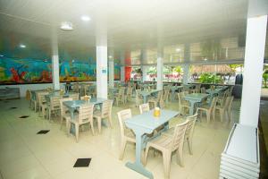 a dining room with tables and chairs in a restaurant at Hotel Playa Divina in Coveñas