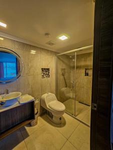 a bathroom with a toilet and a sink and a shower at Plaza Lobos in Puerto Baquerizo Moreno +15 photos