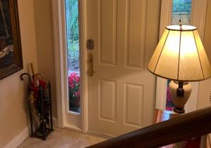 a lamp next to a door with a window at Paradise Gem in Naples