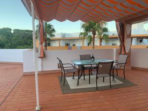 a table and chairs under a tent on a patio at Áticobarco in La Antilla