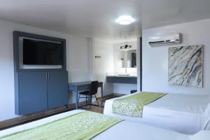 Postel nebo postele na pokoji v ubytování Hotel Aqua Rio