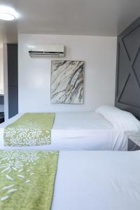 Postel nebo postele na pokoji v ubytování Hotel Aqua Rio
