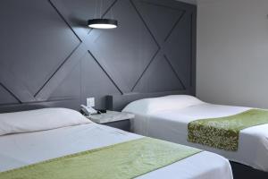 Postel nebo postele na pokoji v ubytování Hotel Aqua Rio