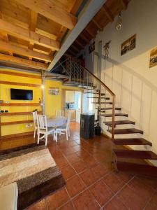 a living room with a staircase and a table and chairs at Casa do Arco da Velha in Bragança