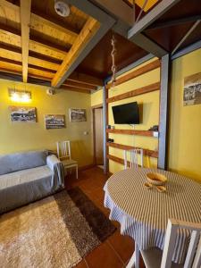 a living room with a couch and a table at Casa do Arco da Velha in Bragança