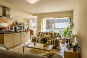 a living room with a couch and a table at L'Appartement in Beaune