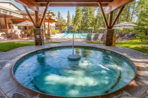 a large pool with a hot tub in a backyard at Gold Bend Escape in Truckee