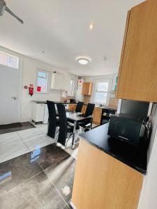 a kitchen and living room with a table and chairs at Room for stay with shared facilities in Uxbridge