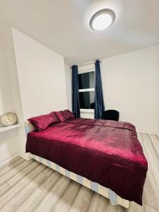 a bedroom with a large bed and a window at Room for stay with shared facilities in Uxbridge