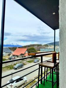 a balcony with a table and a view of a highway at LaLaS APaRT in Ushuaia