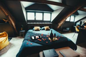 a bedroom with a bed with red roses on it at La Marble Room - Suite balnéo & sauna in Angers