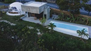 an overhead view of a house with a swimming pool at momo in Kirabaru +28 photos