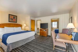 a hotel room with a bed and a desk at Best Western Sunset Inn in Cody +71 photos