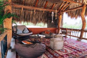 a living room with couches and chairs and a table at Las Dunas Beach in Juan de Acosta