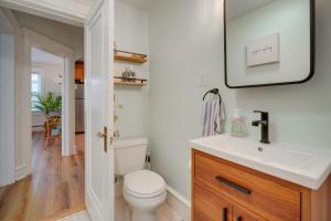 a bathroom with a toilet and a sink and a mirror at Walk to Beach Dog-Friendly Ventnor City Retreat! in Ventnor City +19 photos